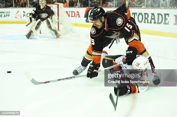 Anaheim Ducks Center Ryan Getzlaf [3505] knocks Calgary Flames Left Wing Micheal Ferland [8525] to the ice during game 5 of round 2 of the Stanley...