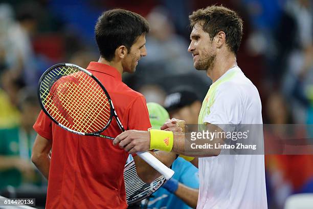 Novak Djokovic of Serbia shakes hands with Mischa Zverev of Germany during day six of Shanghai Rolex Masters at Qi Zhong Tennis Centre on October 14,...