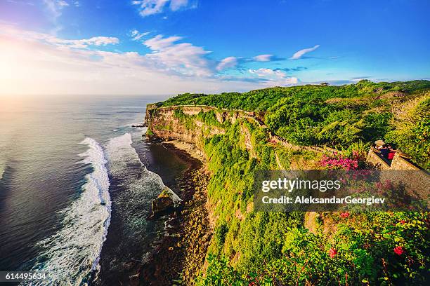 cliff at uluwatu temple on sunset in bali, indonesia - bali temple stock pictures, royalty-free photos & images