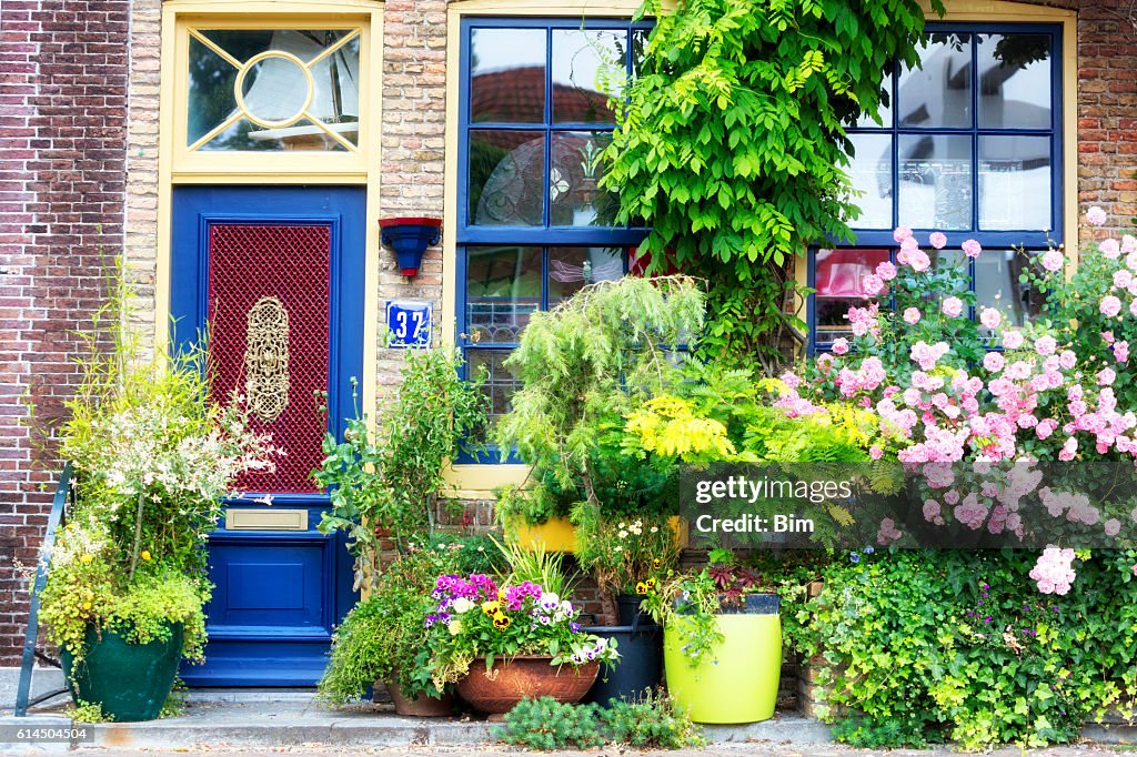 Facade of old house decorated with flowers, Brielle, Netherlands, Europe