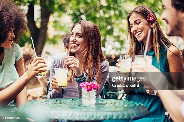 friends having iced drinks outdoors - girlfriend bildbanksfoton och bilder