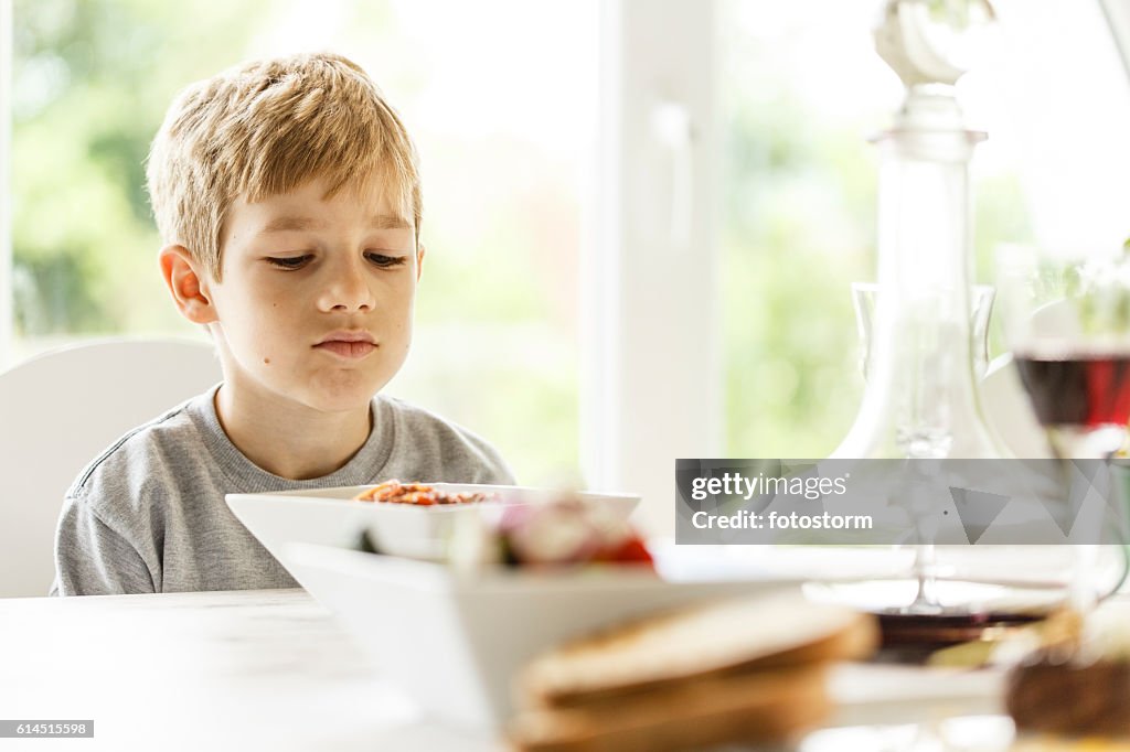 Boy unhappy with his lunch