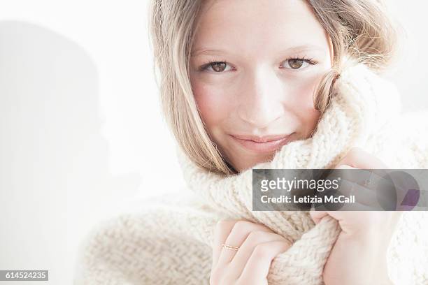 blond woman wears a cosy woolen pull-over - maglione foto e immagini stock