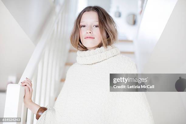 woman in a staircase wears white pull-over - lana foto e immagini stock