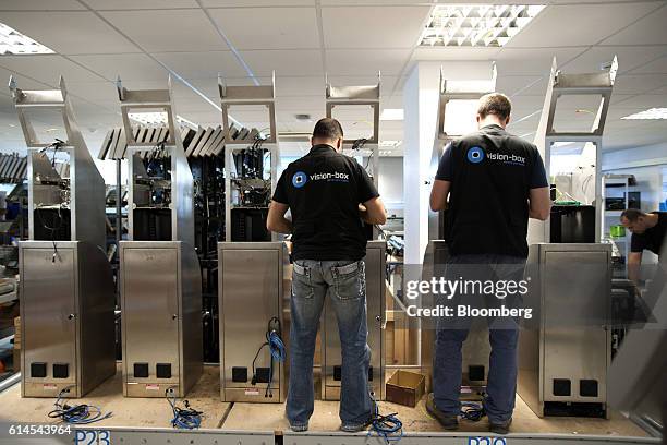 Technicians work on the assembly of vb e-pass Kiosk used for live biometric enrollment at the Vision-Box Solucoes De Visao Por Computador SA offices...