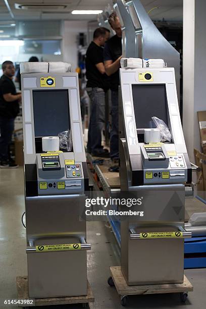 Technicians work on the assembly of vb e-pass Kiosk used for live biometric enrollment at the Vision-Box Solucoes De Visao Por Computador SA offices...