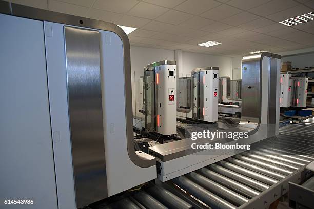 Automated Border Control e-Gates which use facial recognition technology for airport security sit during assembly at the Vision-Box Solucoes De Visao...