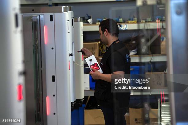 Technician assembles an Automated Border Control e-Gate which uses facial recognition technology for airport security at the Vision-Box Solucoes De...