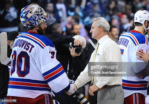 Kings coach Darryl Sutter shakes the hand of New York Rangers Goalie Henrik Lundqvist [2585] during the post game celebration of the Stanley Cup...