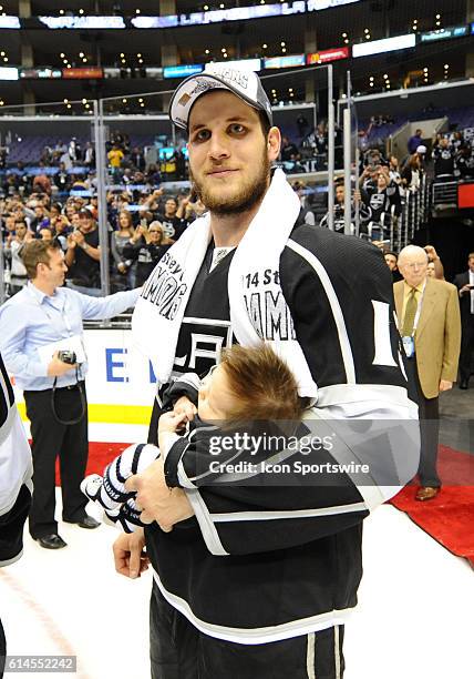 Los Angeles Kings Left Wing Kyle Clifford [7370] holds his 8 week old son Brody Clifford during the post game celebration of the Stanley Cup Final...