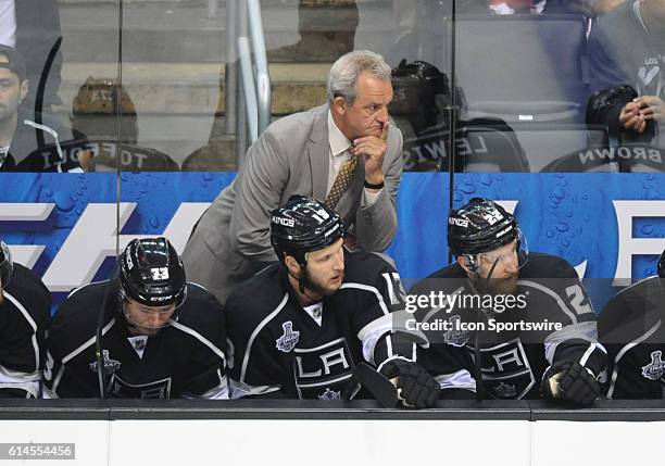 Kings coach Darryl Sutter watches attentively from the bench during game 5 of the Stanley Cup Final between the New York Rangers and the Los Angeles...