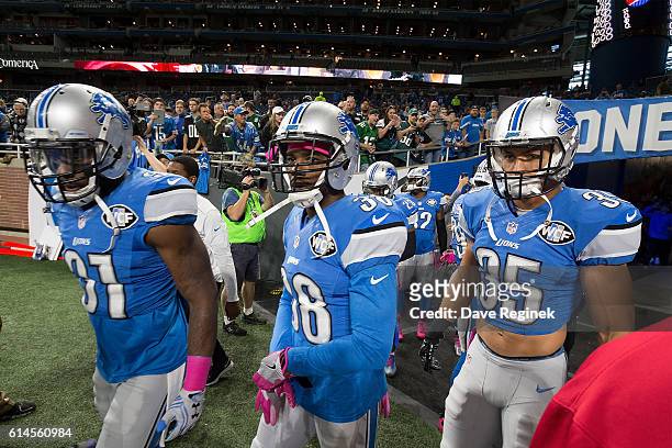 Rafael Bush, Adairius Barnes and Miles Killebrew of the Detroit Lions head out to the field before the start of an NFL game against the Philadelphia...