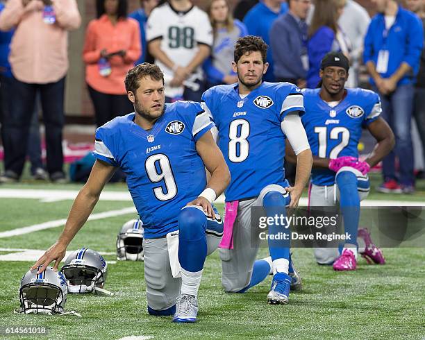 Matthew Stafford, Dan Orlovsky and Andre Roberts of the Detroit Lions warms up before an NFL game against the Philadelphia Eagles at Ford Field on...