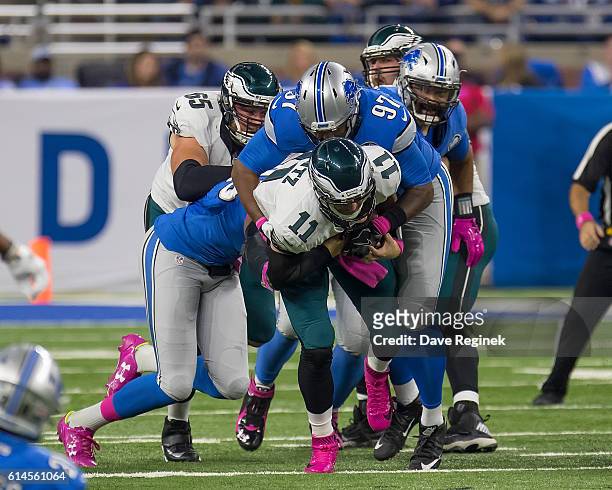 Armonty Bryant of the Detroit Lions tackles Carson Wentz of the Philadelphia Eagles during an NFL game at Ford Field on October 9, 2016 in Detroit,...
