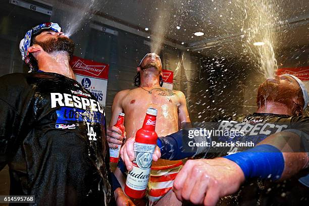 Adrian Gonzalez , Josh Reddick and Justin Turner of the Los Angeles Dodgers celebrate in the clubhouse after winning Game Five of the National League...