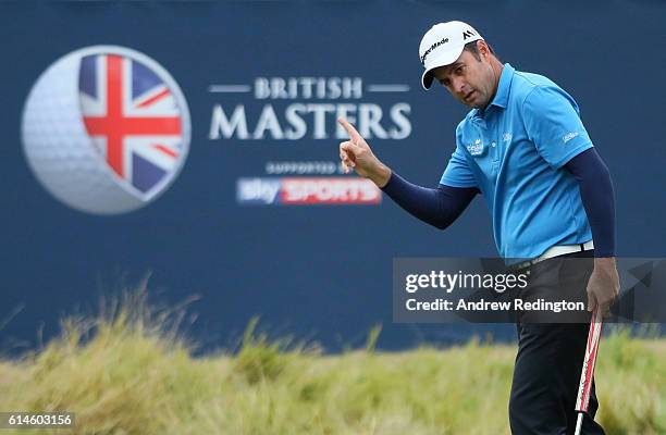 Richard Bland of England takes a one shot lead after making a birdie putt on the 18th hole during the second round of the British Masters at The...