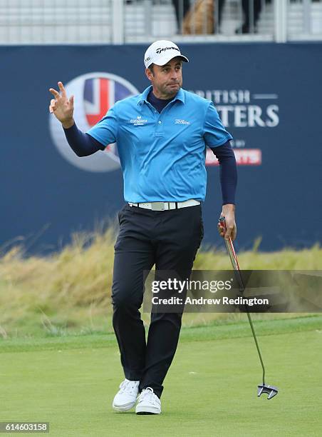 Richard Bland of England takes a one shot lead after making a birdie putt on the 18th hole during the second round of the British Masters at The...