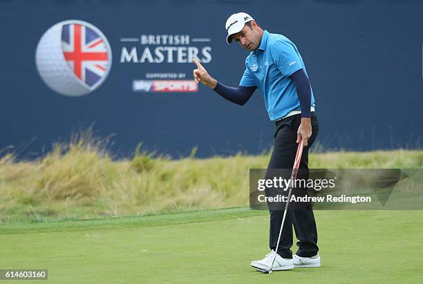 Richard Bland of England takes a one shot lead after making a birdie putt on the 18th hole during the second round of the British Masters at The...