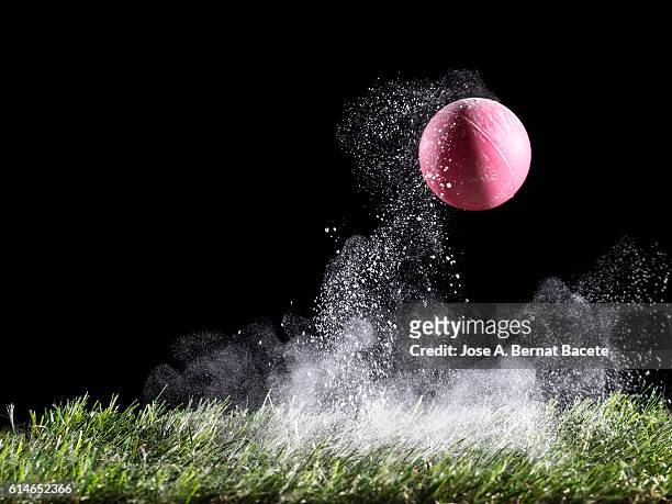 cloud of white powder produced by the impact of a ball on the lawn of grass - force physics stock pictures, royalty-free photos & images
