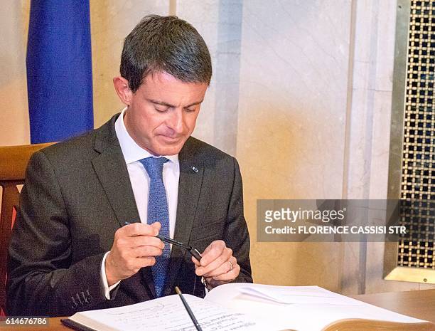 French Prime Minister Manuel Valls arrives at the National Assembly of Quebec and signs a guest book in Quebec City, Quebec, on October 14, 2016. The...