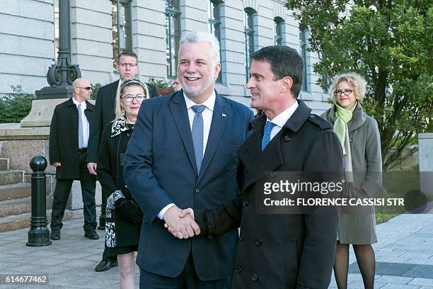 French Prime Minister Manuel Valls shakes hands as he arrives at the National Assembly of Quebec with Quebec Premier Philippe Couillard in Quebec...