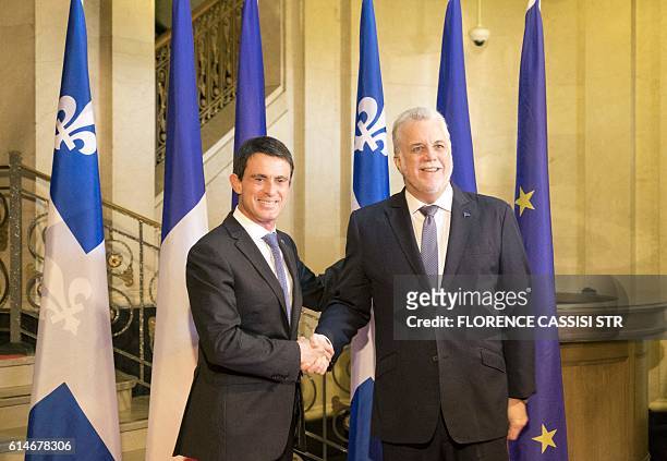 French Prime Minister Manuel Valls shakes hands as he arrives at the National Assembly of Quebec with Quebec Premier Philippe Couillard in Quebec...