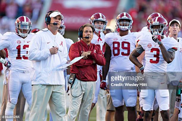 Offensive Coordinator Lane Kiffin and Head Coach Nick Saban of the Alabama Crimson Tide watch a replay on the scoreboard during a game against the...