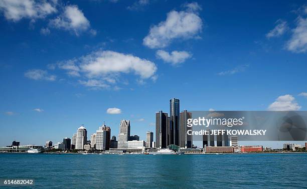 The USS Detroit comes up the Detroit River on the way to be docked in by the Renaissance Center in Detroit, Michigan on October 14, 2016 as seen from...