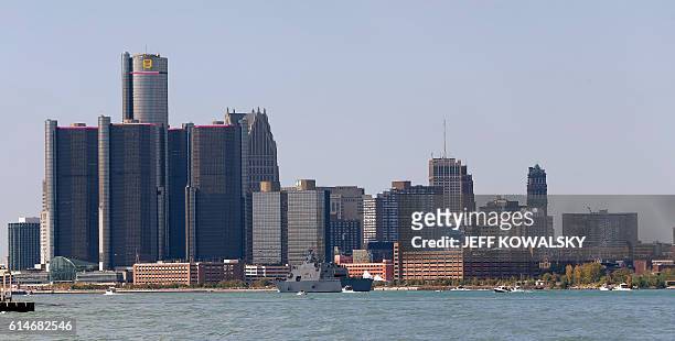 The USS Detroit comes up the Detroit River on the way to be docked in by the Renaissance Center in Detroit, Michigan on October 14, 2016 as seen from...