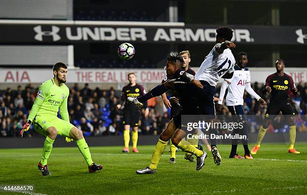 Shayon Harris of Tottenham Hotspuron takes a shot at goal under pressure from Demeaco Duhaney of Manchester City during the Premier League 2 match...