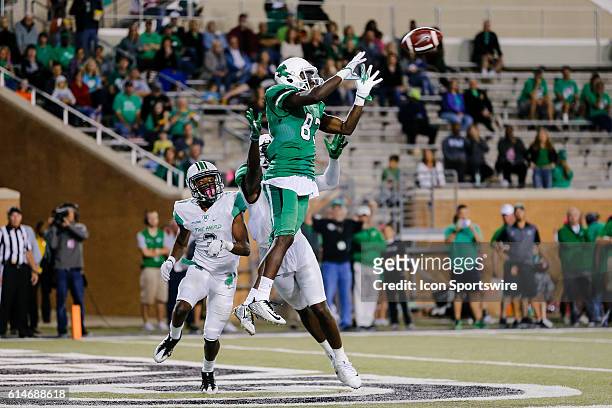 North Texas Mean Green wide receiver Tyler Wilson goes up for the football in front of Marshall Thundering Herd defensive back Chris Jackson and...
