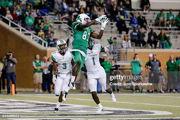North Texas Mean Green wide receiver Tyler Wilson goes up for the football in front of Marshall Thundering Herd defensive back Chris Jackson and...