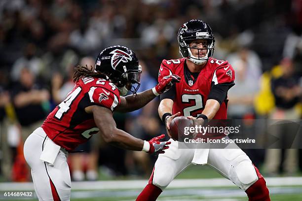 Atlanta Falcons Quarterback Matt Ryan hands the ball off to Atlanta Falcons Running Back Devonta Freeman during a game against the New Orleans Saints...