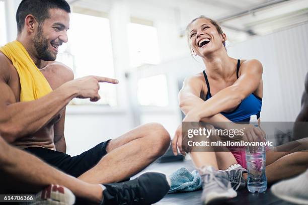 smiling young athletes refreshing after training - active people gym stock pictures, royalty-free photos & images