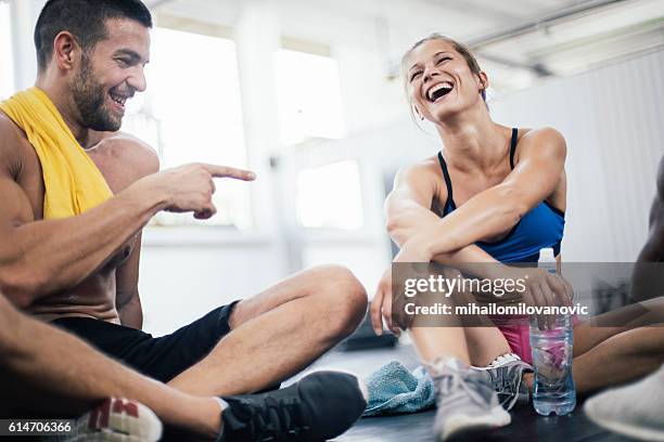 smiling young athletes refreshing after training - sports training bildbanksfoton och bilder