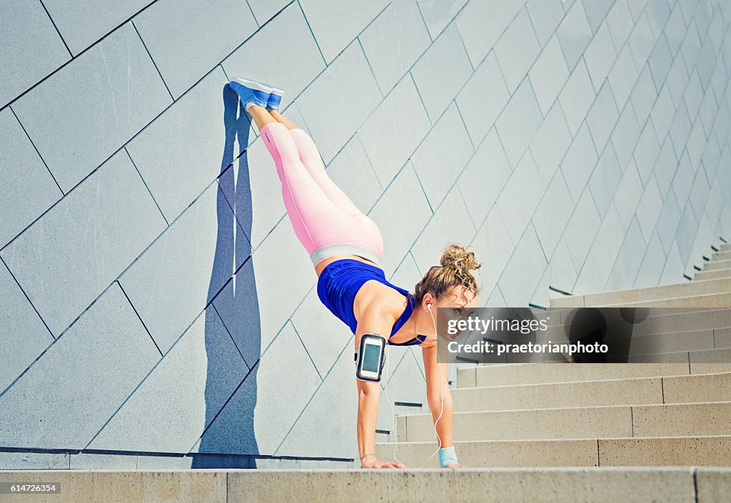 Girl is stretching on the city stairs