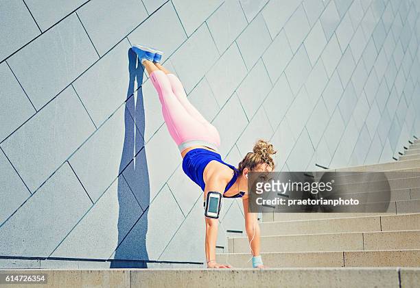 girl is stretching on the city stairs - leg stretch girl stock pictures, royalty-free photos & images
