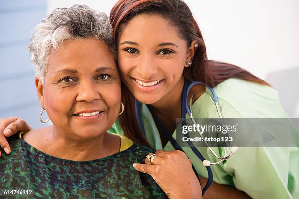 caring, mixed-race nurse and senior adult patient in hospital. - volunteer aged care stock pictures, royalty-free photos & images