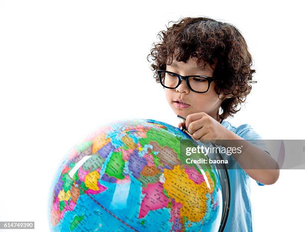young asian boy with globe against white background - desktop globe stock pictures, royalty-free photos & images