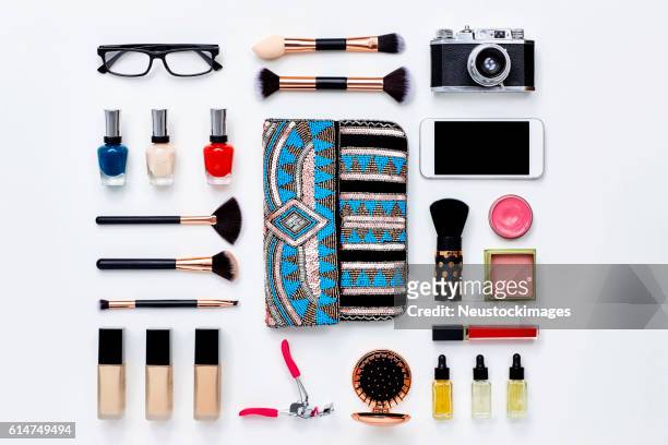 clutch bag surrounded with beauty products and technologies - knolling tools stock pictures, royalty-free photos & images