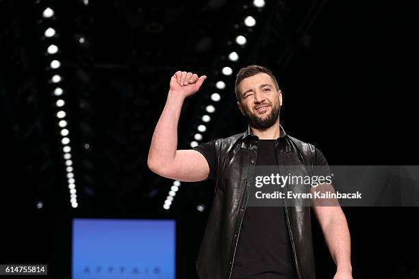Rufat Ismayil is applauded on the runway at the Afffair show during Mercedes-Benz Fashion Week Istanbul at Zorlu Center on October 14, 2016 in...