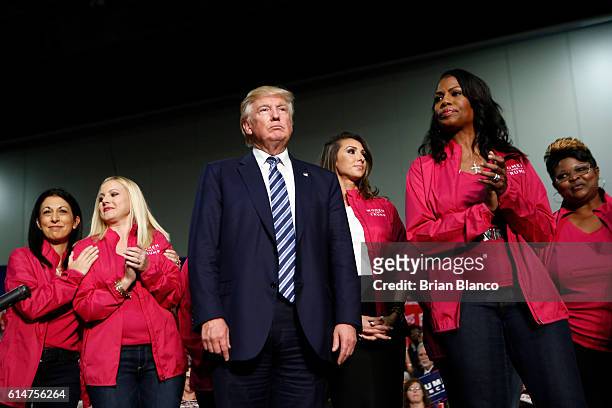 Republican presidential candidate Donald Trump stands with Women for Trump as he speaks to supporters at a rally on October 14, 2016 at the Charlotte...