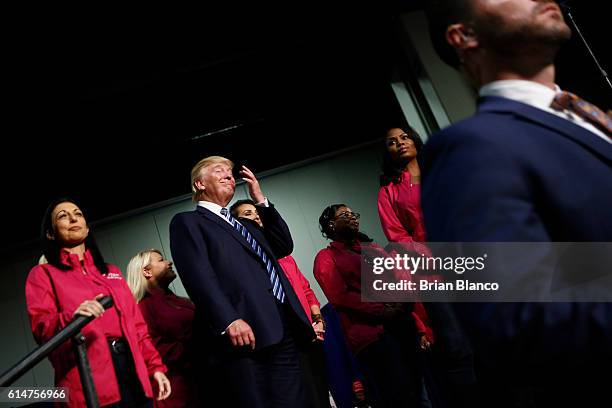 Republican presidential candidate Donald Trump stands with Women for Trump as he speaks to supporters at a rally on October 14, 2016 at the Charlotte...