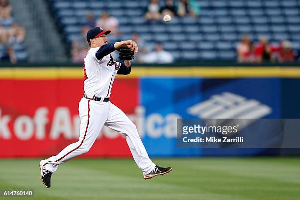 Kelly Johnson of the Atlanta Braves fields a ball during the game against the Philadelphia Phillies at Turner Field on May 12, 2016 in Atlanta,...