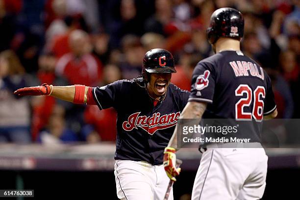 Francisco Lindor of the Cleveland Indians celebrates with teammate Mike Napoli after hitting a two run home run to right field against Marco Estrada...