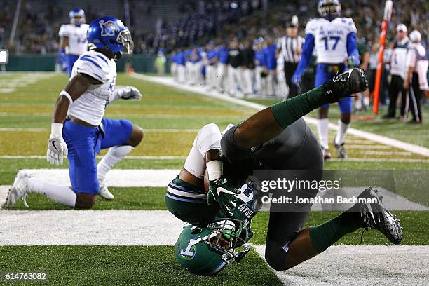 Tight end Kendall Ardoin of the Tulane Green Wave scores a touchdown over defensive back Arthur Maulet of the Memphis Tigers during the first half of...