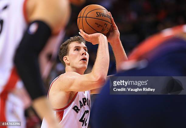 Jakob Poeltl of the Toronto Raptors shoots a free throw during the second half of an NBA preseason game against San Lorenzo de Almagro at Air Canada...