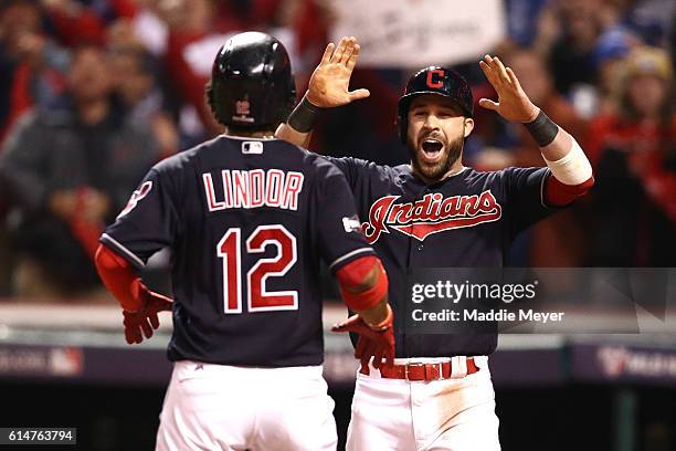 Francisco Lindor of the Cleveland Indians celebrates with teammate Jason Kipnis after hitting a two run home run to right field against Marco Estrada...