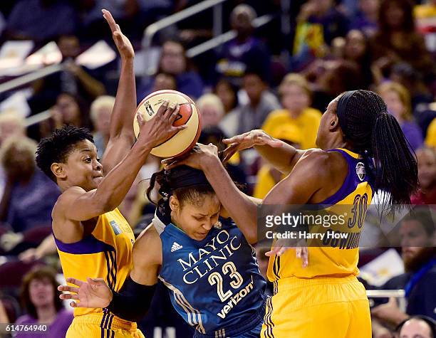 Forward Maya Moore of the Minnesota Lynx gets trapped by guard Alana Beard and forward Nneka Ogwumike of the Los Angeles Sparks in game three of the...