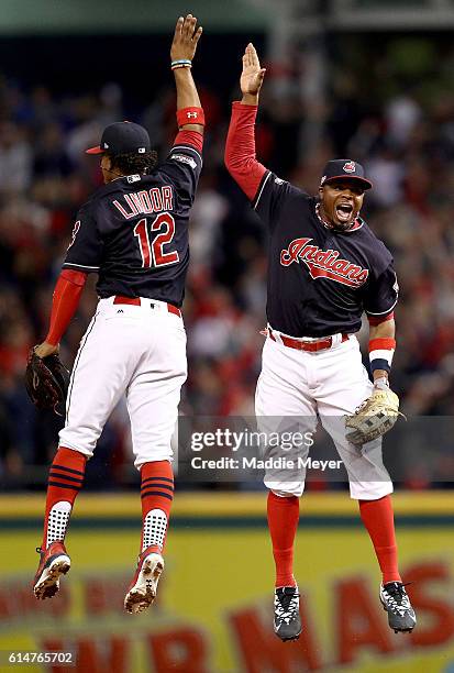 Francisco Lindor of the Cleveland Indians celebrates with teammate Rajai Davis after defeating the Toronto Blue Jays with a score of 2 to 0 in game...